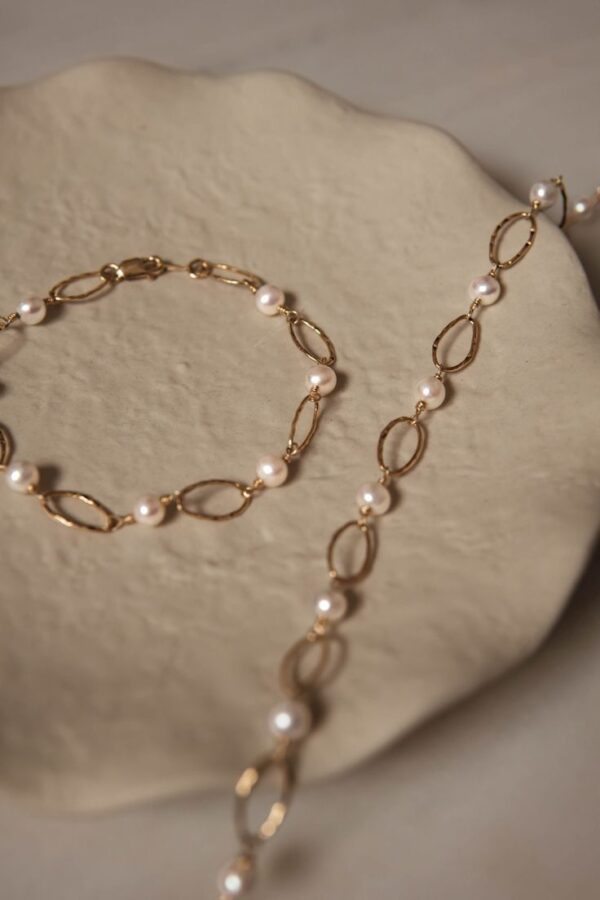 Collar y pulsera a conjunto con perlas y óvalos dorados intercalados.